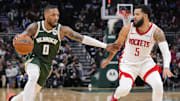 Nov 18, 2024; Milwaukee, Wisconsin, USA;  Milwaukee Bucks guard Damian Lillard (0) drives for the basket against Houston Rockets guard Fred VanVleet (5) during the third quarter at Fiserv Forum. Mandatory Credit: Jeff Hanisch-Imagn Images